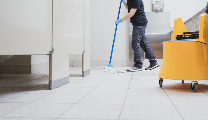 A professional cleaning bathroom floor A professional cleaning bathroom floor