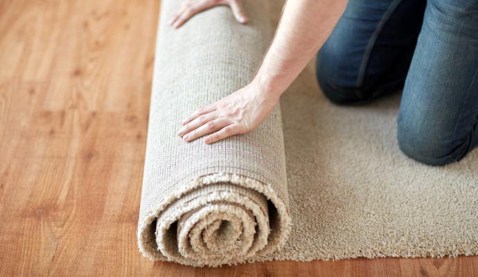 Person unrolling carpet